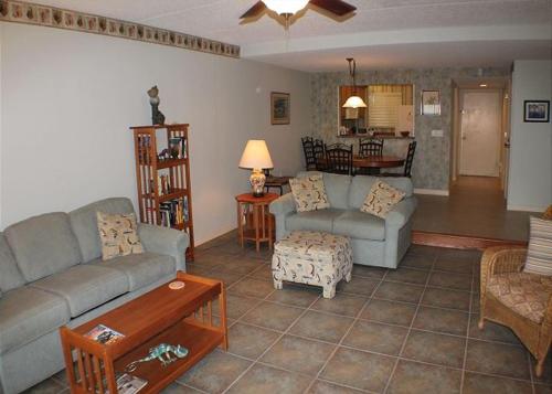 a living room with two couches and a table at Summerhouse 228 Condo in Saint Augustine