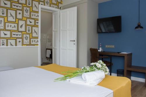 a bedroom with a bed with a vase of flowers on it at Ditlin in Pápa