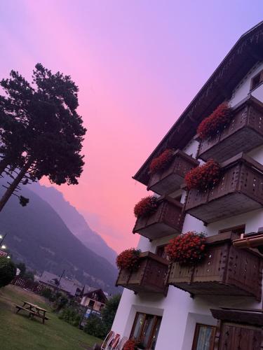 a building with flower boxes on the side of it at Hotel Villa Rina in Bormio