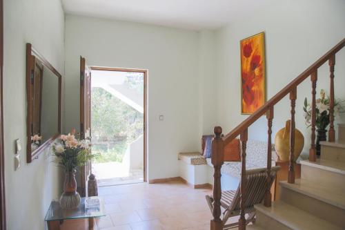 a living room with a staircase and a stair case at J&B Countryside Life - Just for two in Ágios Matthaíos