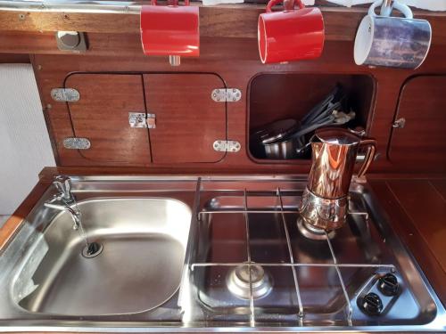 a sink in a kitchen with a counter top at Cafe Sander´s Camping auf der Mosel in Winningen