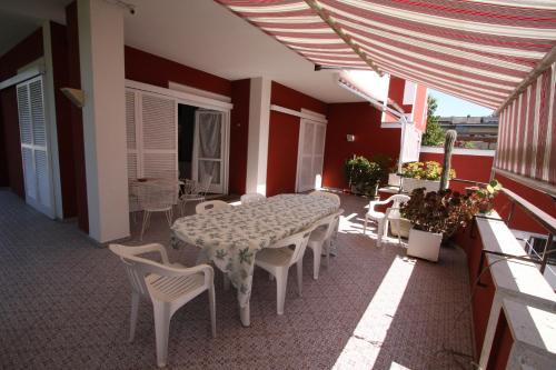 a patio with a table and chairs on a balcony at Villa della Tartaruga in Casal Palocco