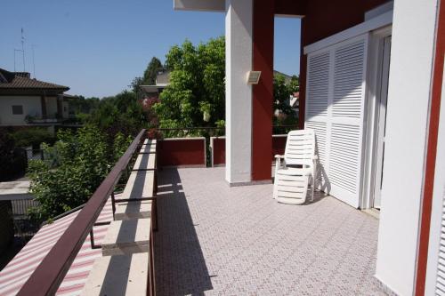 a balcony with two chairs and a building at Villa della Tartaruga in Casal Palocco