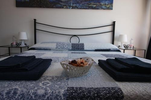 a bedroom with a bed with a basket of fruit on it at Villa della Tartaruga in Casal Palocco