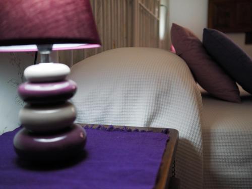 a close up of a purple table with a small lamp at Hospedium Hostal Almanzor in Navarredonda de Gredos