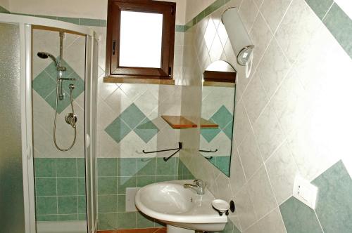 a bathroom with a sink and a shower at La Fattoria in Castelsardo