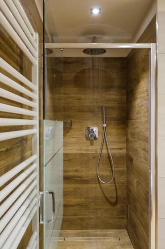 a bathroom with a shower with a glass door at Chalet Bellavista in Livigno