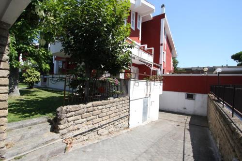a house with a fence and stairs in front of it at Villa della Tartaruga in Casal Palocco