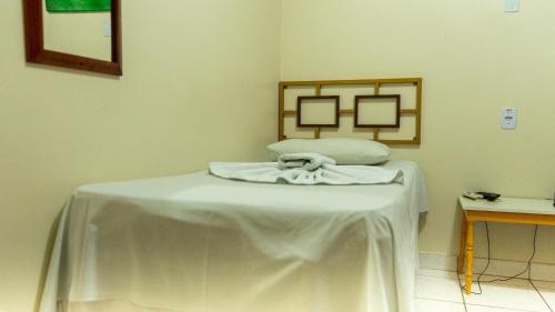 a room with a table with a white table cloth on it at Hotel Itaipu in Goiânia