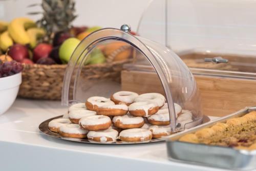a pile of donuts on a plate on a counter at Marvarit Suites in Mesaria