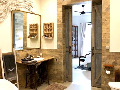 a bathroom with a sink and a mirror at Puri Kasih Gottlieb in Ubud
