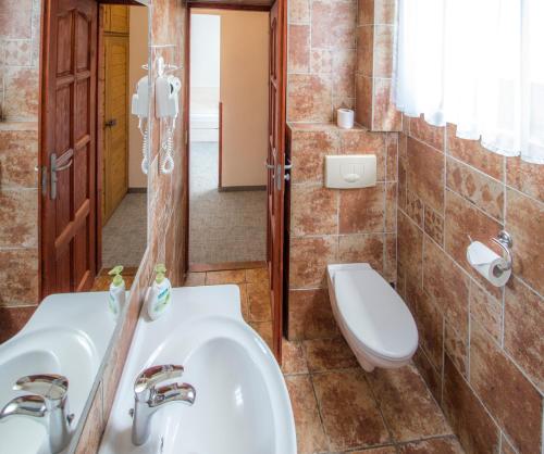 a bathroom with a sink and a toilet at Renegade Hotel in Siófok