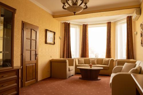 a living room with a couch and a table at Diplomat Club Hotel in Chişinău