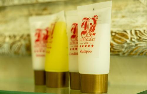 a row of bottles of hair products on a shelf at Diplomat Club Hotel in Chişinău