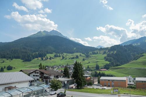 a view of a village with mountains in the background at B&B La Tgamona in Savognin