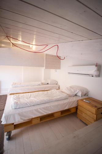 a bedroom with two beds and a light fixture at Renegade Hotel in Siófok
