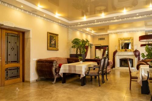 a living room with a table and a couch at Diplomat Club Hotel in Chişinău