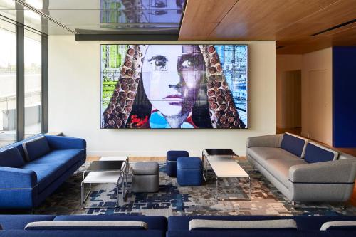 a living room with couches and a large painting on the wall at YOOMA Urban Lodge Tour Eiffel in Paris