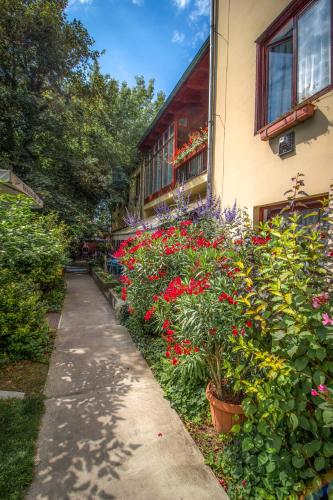 a sidewalk next to a building with flowers on it at Renegade Hotel in Siófok