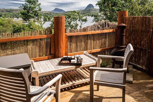 a patio with a table and two chairs and a grill at The Hideaway in Lochinver