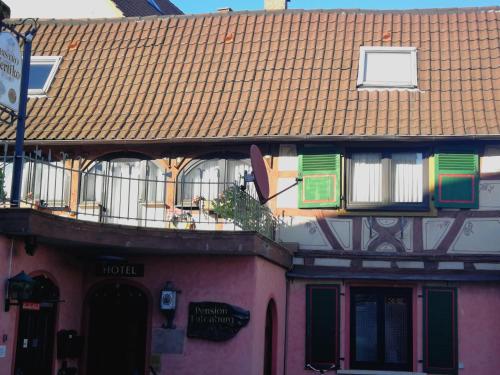 a pink building with a roof and a balcony at Eulenburg in Rülzheim