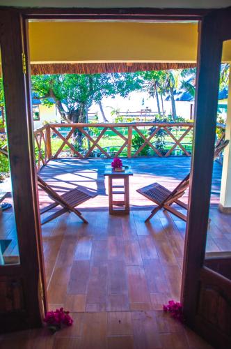 an open door to a porch with a table on a patio at Vilancool Beach Resort in Vilanculos