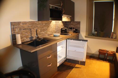 a kitchen with a sink and a counter top at The Victoria Inn Blythswood Snug in Falkirk