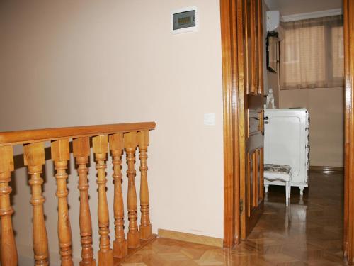 a hallway with a staircase and a white refrigerator at Two Towers Guest House in Kutaisi