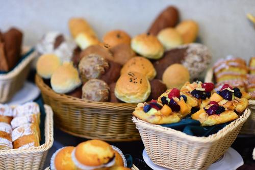 a bunch of baskets filled with different types of pastries at Saraya Corniche Hotel in Doha