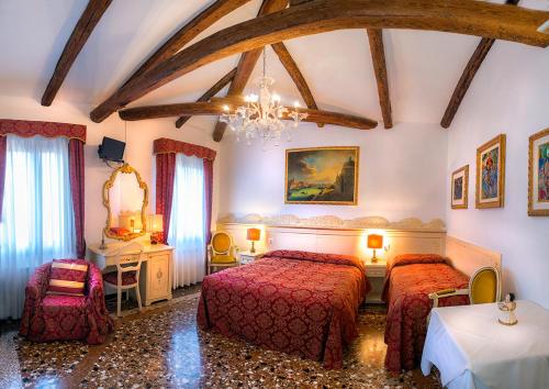 a bedroom with two beds and a chandelier at Aquavenice Locazione Turistica in Venice
