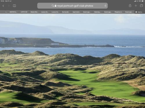 a rendering of a golf course with the ocean in the background at Luxury South Pier Apartment in Portrush