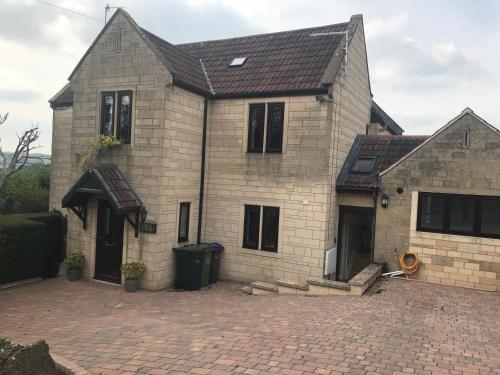 a large brick house with a brick driveway at A secluded self contained Country Suite with a view - parking, easy access to Bath in Corsham