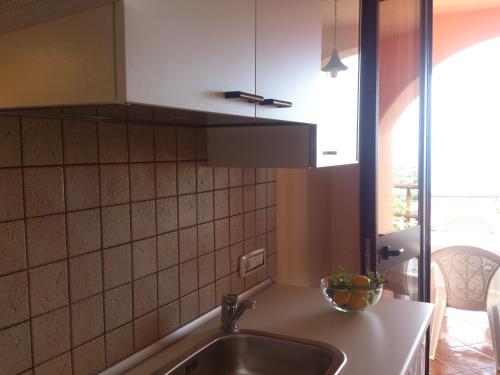 a kitchen with a sink and a counter top at B&B Dimora Marchese in Marina di Camerota