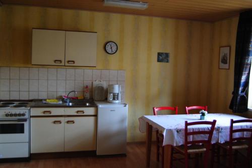 a kitchen with a table and a stove and a table and chairs at Gut Dankerode in Dankerode