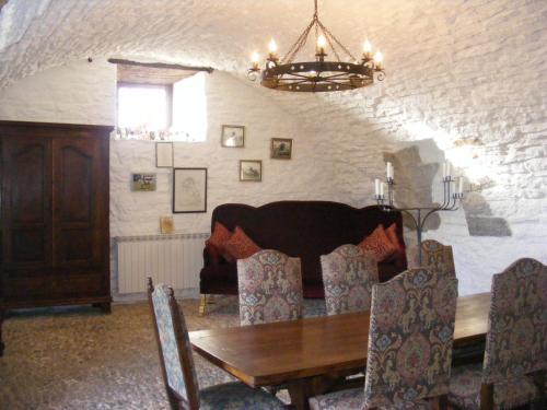 a dining room with a wooden table and chairs at Château de Laumière in Promilhanes