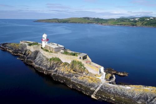 a lighthouse on an island in the water at Lighthouse Cottage in Donegal