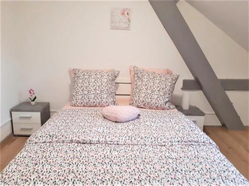 a bedroom with a bed and two pillows at MyHome Basel 3A46 in Saint-Louis