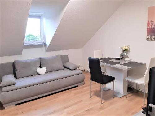 a living room with a couch and a table at MyHome Basel 3A46 in Saint-Louis