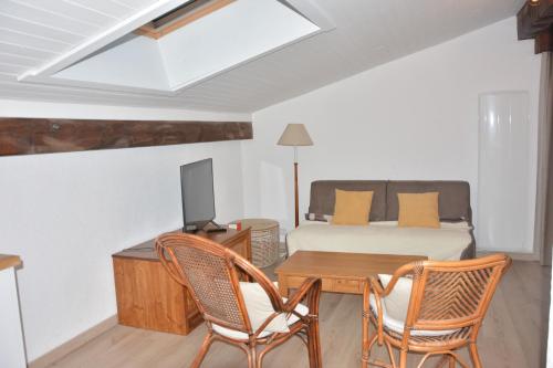 a room with a bed and a table and chairs at Saint Gervais - Le Bettex T3 Duplex (1400m d'altitude)/ 55m2 / Vue Mont Blanc - Aux Pieds des Pistes! in Saint-Gervais-les-Bains
