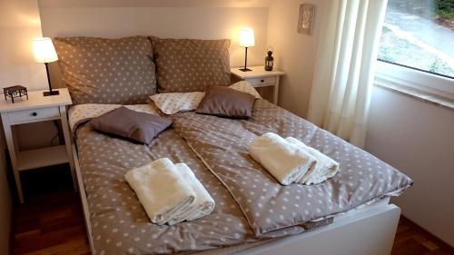 a bed in a room with two pillows on it at Domek Gościnny Dyziówka in Szczyrk