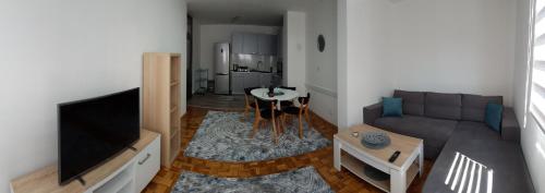 a living room with a couch and a flat screen tv at Apartment Emina in Travnik