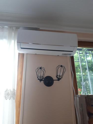 a kitchen stove with two bird cages on the wall at agmashenebeli95 in Tbilisi City