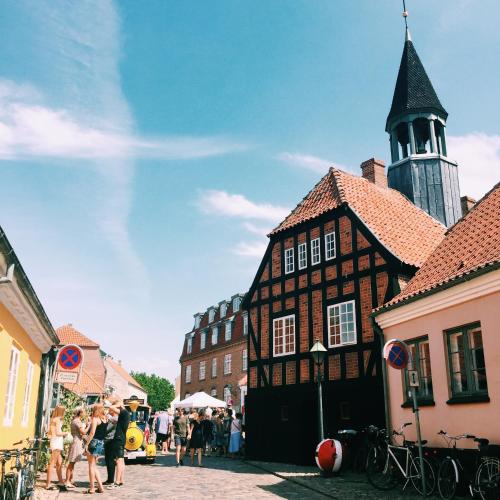 a group of people standing in front of a building at Ebeltoft Midtby in Ebeltoft