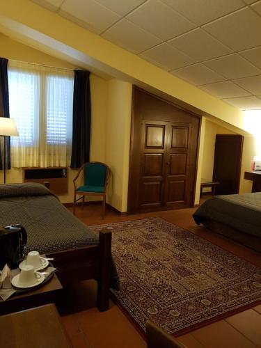 Postel nebo postele na pokoji v ubytování Corsaro Etna Hotel&SPA