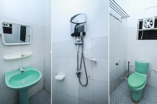 a bathroom with a green toilet and a shower at Green Palace Colombo in Colombo