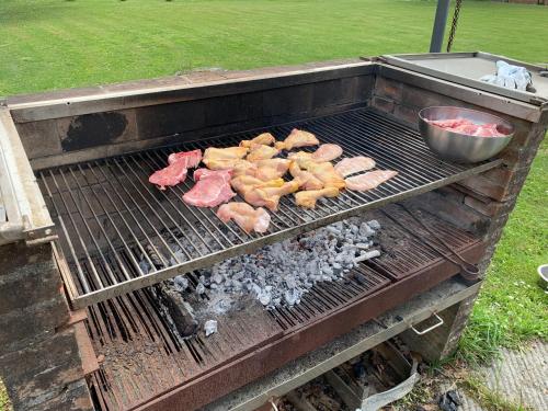 a grill with a bunch of meat on it at B&B La Fornace del Sole in Capannori