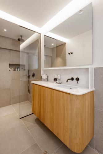 a bathroom with a sink and a shower at ELADIA Suites in Neos Marmaras