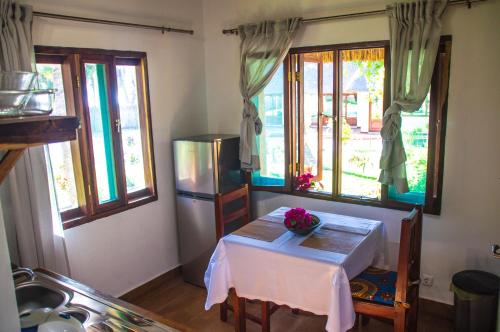 a kitchen with a table and some windows at Vilancool Beach Resort in Vilanculos