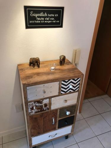 a dresser with two elephants on top of it at Apartment Green Elephant in Tettnang