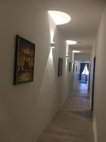 a hallway with paintings on the walls of a building at COMFORTABLE STAY in Ayer Itam